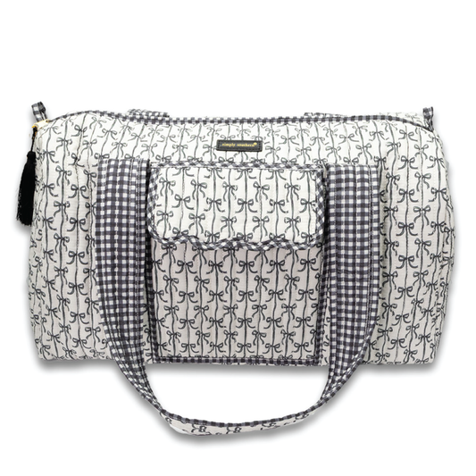 Quilted duffle bag in black-and-white script with gingham front pocket and handles