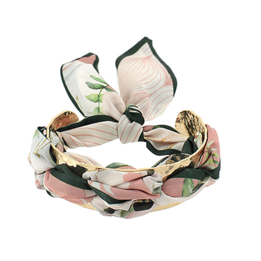 Twisted leaf-print scarf bracelet with pink, green, and black fabric.