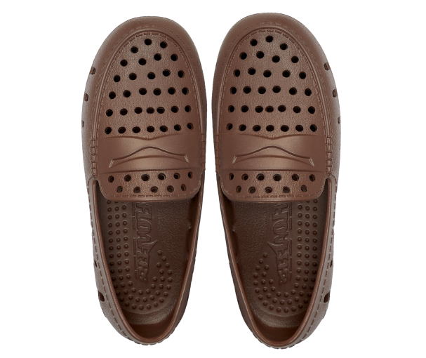 Kids brown loafer bottoms with circular grip dots and embossed logo detail