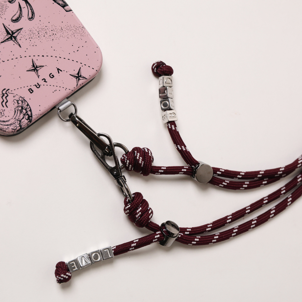 Burgundy phone strap with stitched tag, metal clasps, and adjustable length cords