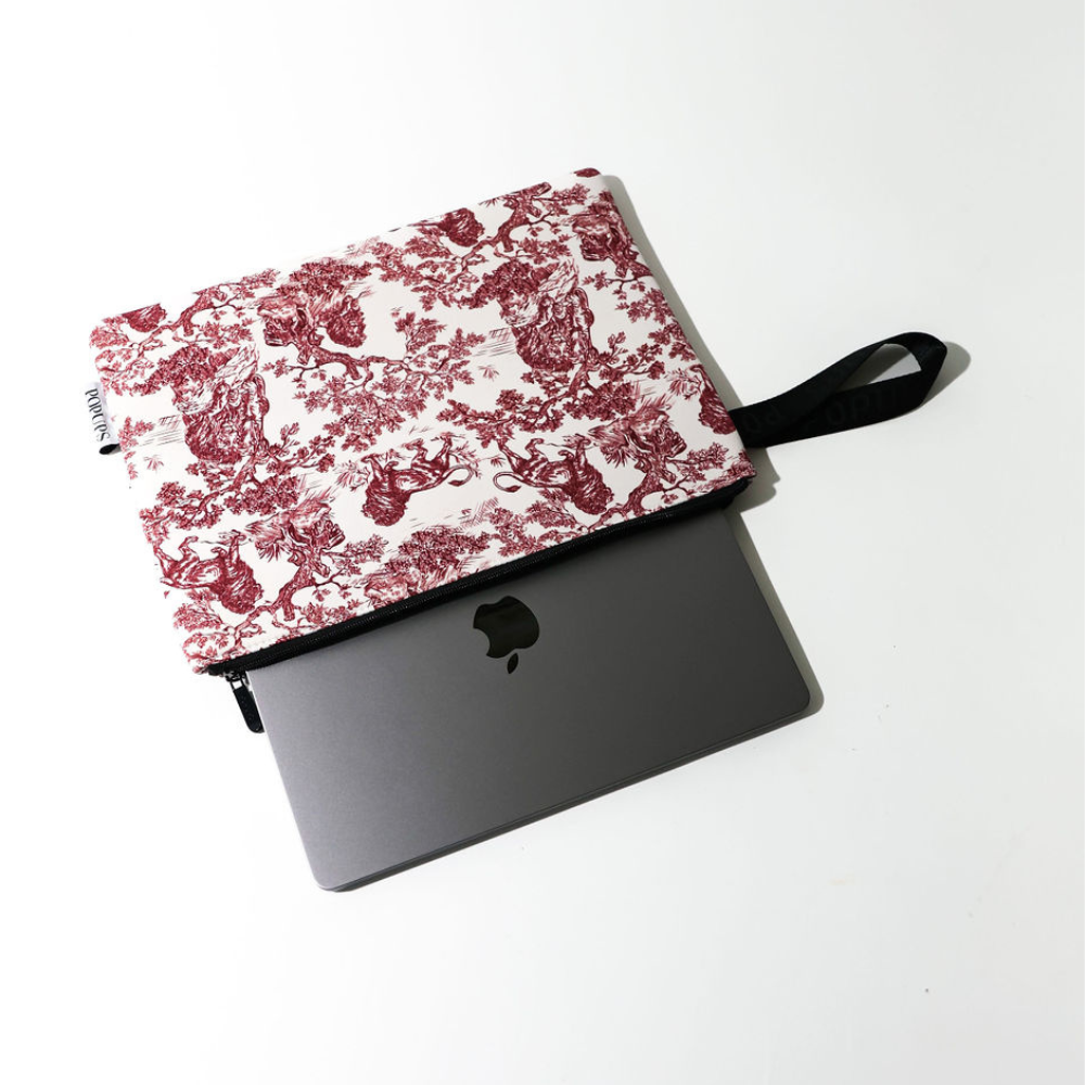 Laptop sleeve with maroon toile flap and black zipper, gray base with Apple icon
