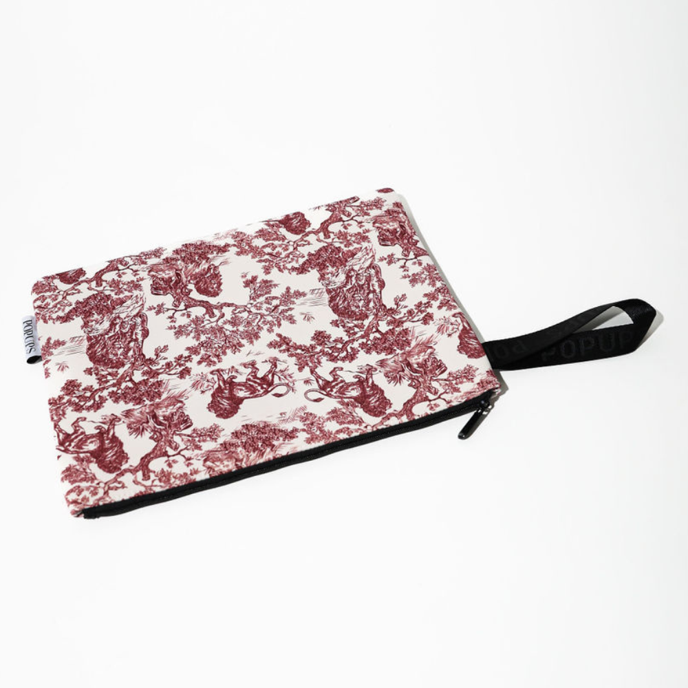 Maroon and white toile laptop sleeve with black trim and back carrying strap