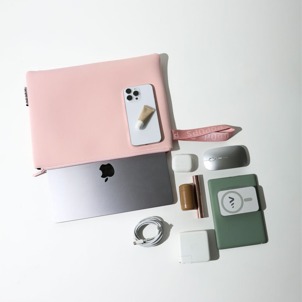 Pink laptop sleeve with flap open, showing interior and attached wrist strap