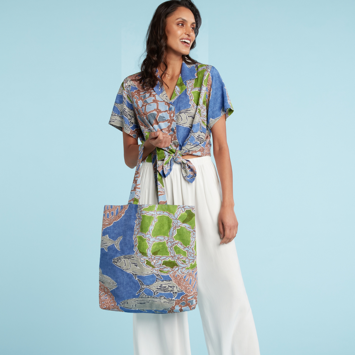 Fishing-themed tote bag with long handles; blue print of fish, ropes, floats