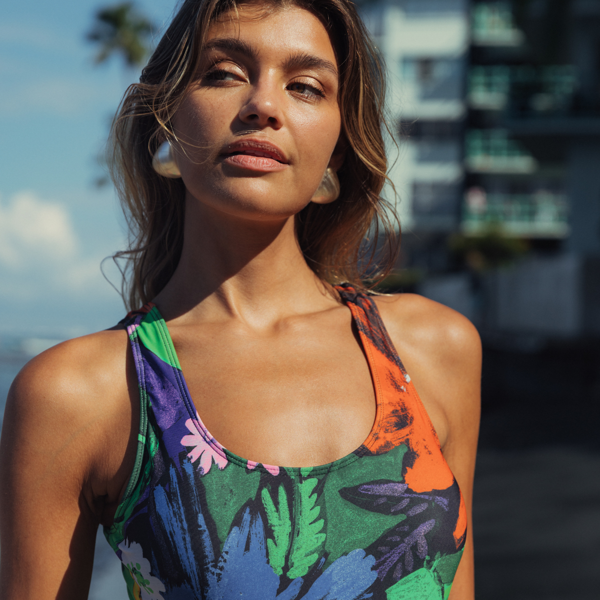 Multicolor tropical floral one-piece swimsuit with scoop neckline and racerback straps.