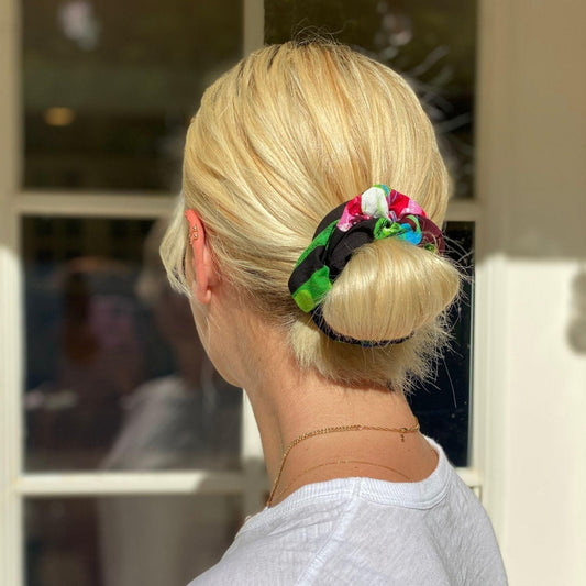 Multicolor floral scrunchie tied in blonde ponytail