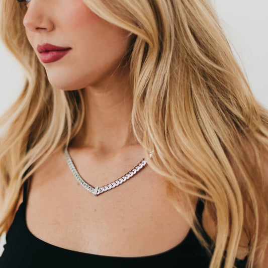 Silver diamond V necklace on model neckline, chevron V pendant with stones