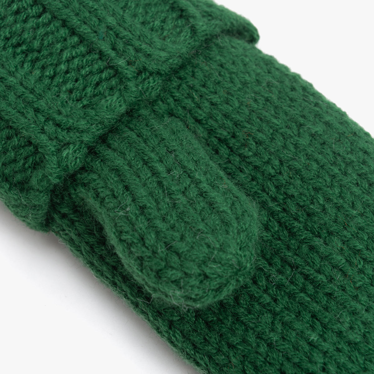Close-up of the green mittens' chunky knit texture