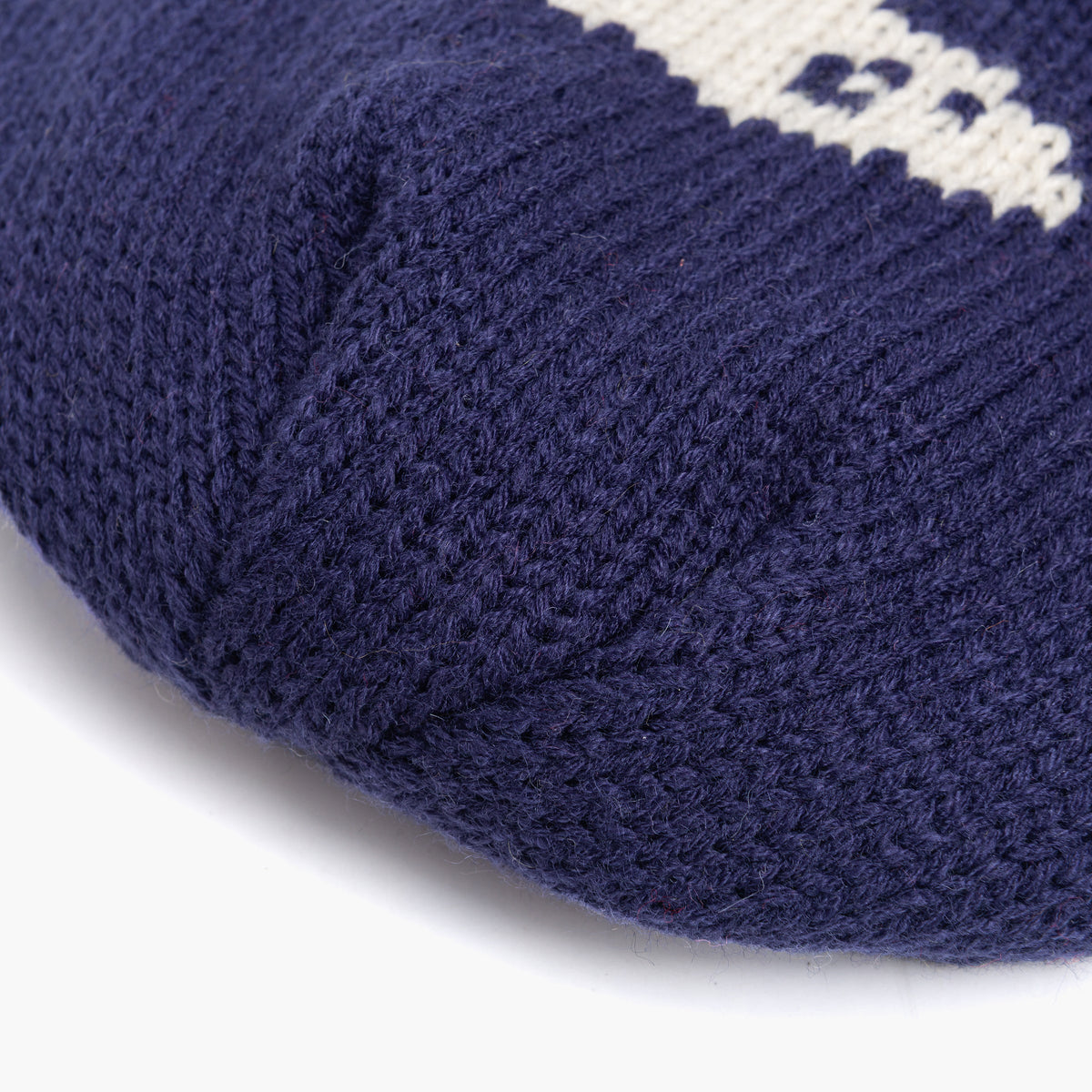 Close-up of the navy beanie's textured knit fabric