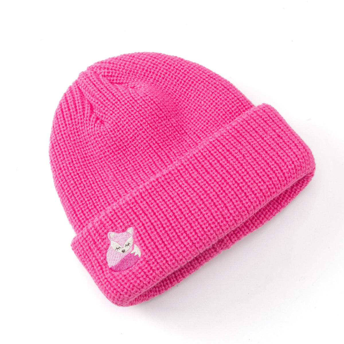 Bright pink knitted beanie with a small fox patch on the cuff