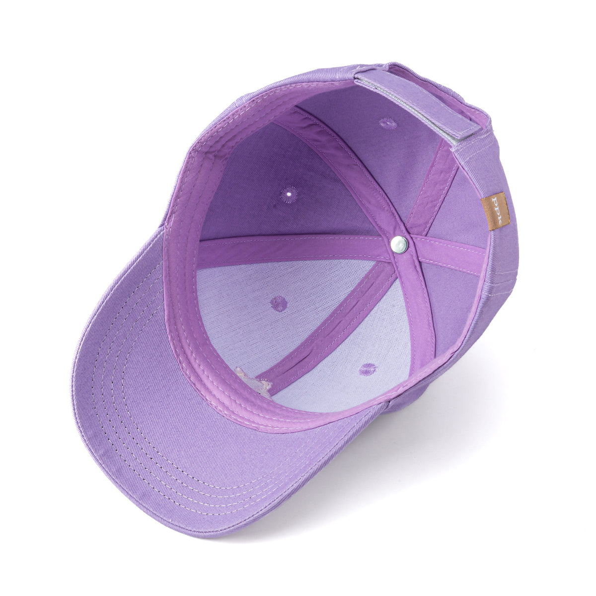 Inside of the purple cap showing stitched panels, sweatband, and adjustable strap