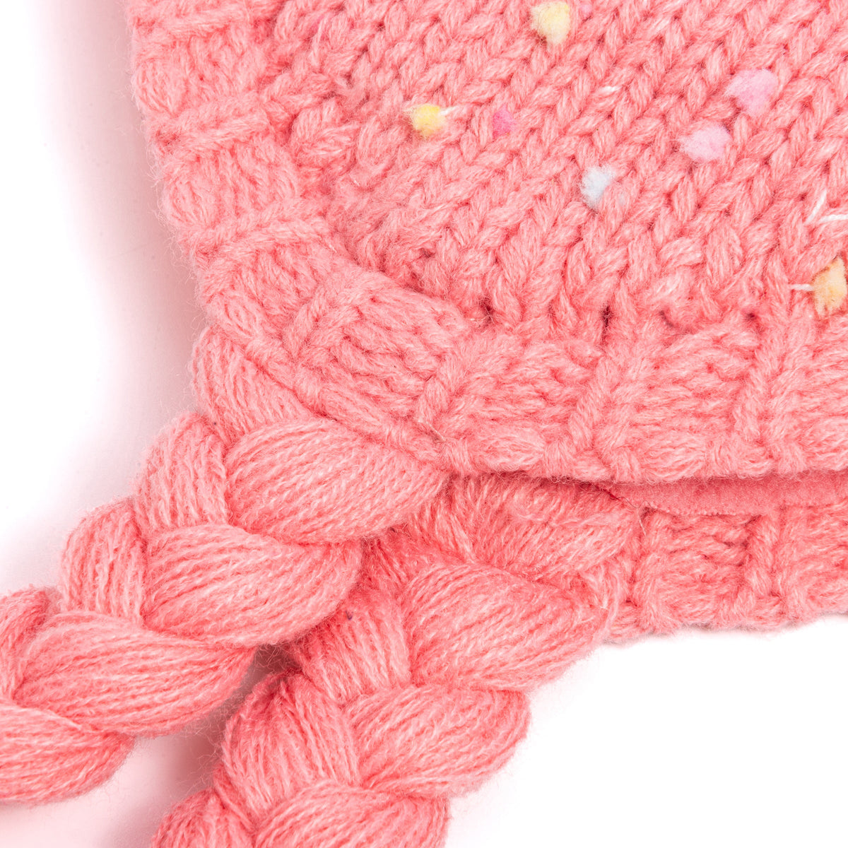Close-up of the knit edge and braided ties on a pink earflap hat