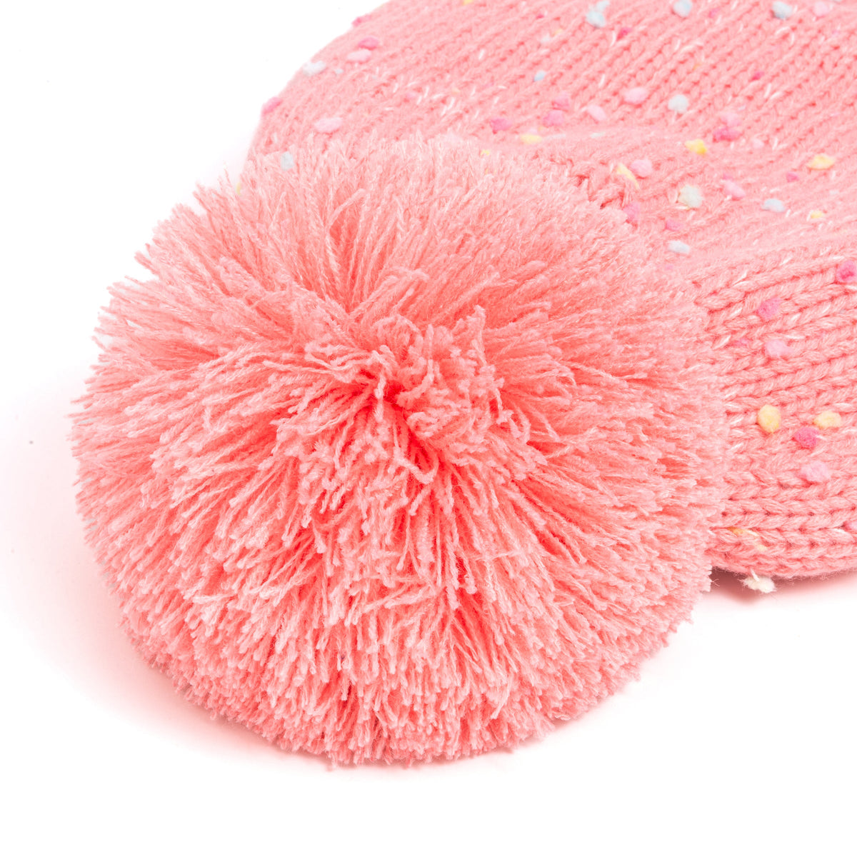 Close-up of the fluffy pom-pom and flecked knit on a pink earflap hat