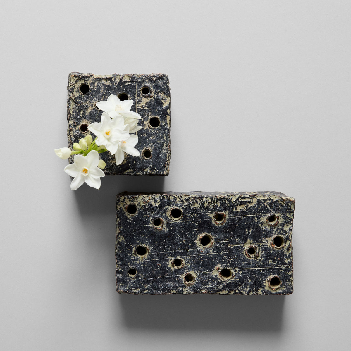 Ceramic frog block set of two, grey patina with flower cutouts and white blossoms