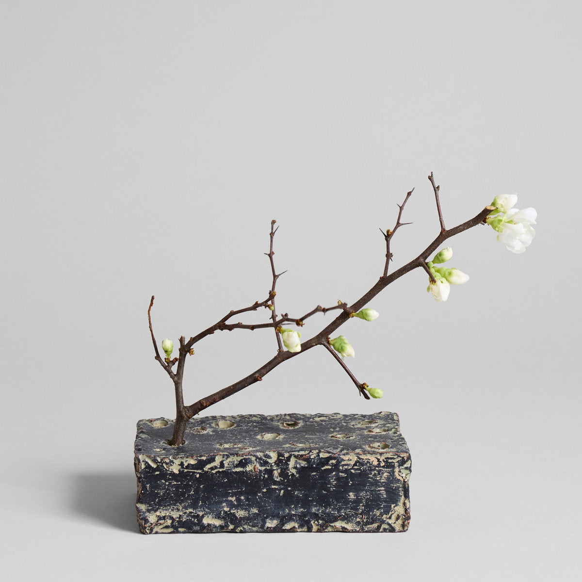 Ceramic frog block with distressed grey patina base and branch with white flowers