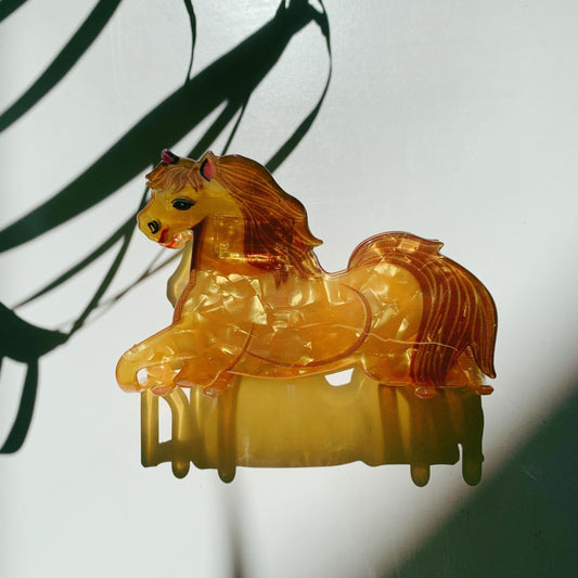 Gold tone horse-shaped hair claw with dripping mane, glossy resin finish