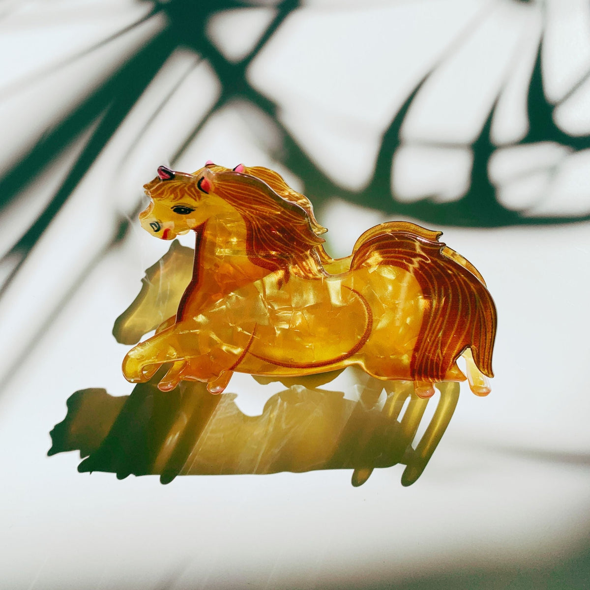 Amber gold horse hair claw with sculpted mane and dripped tail detail