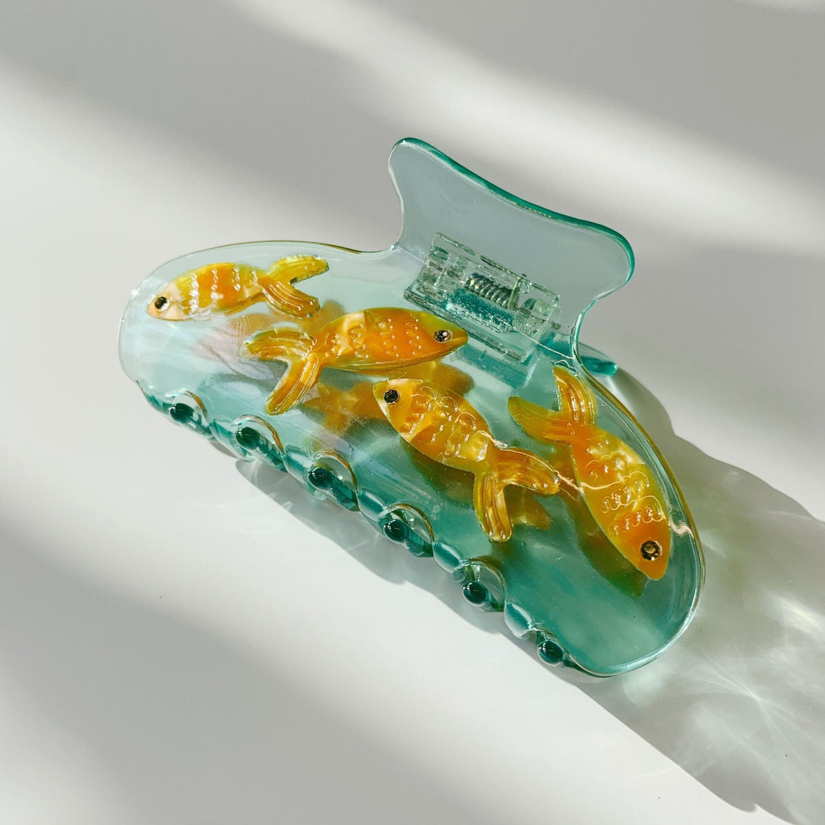 Goldfish hair claw clip, teal transparent shell with orange-gold fish and clasp