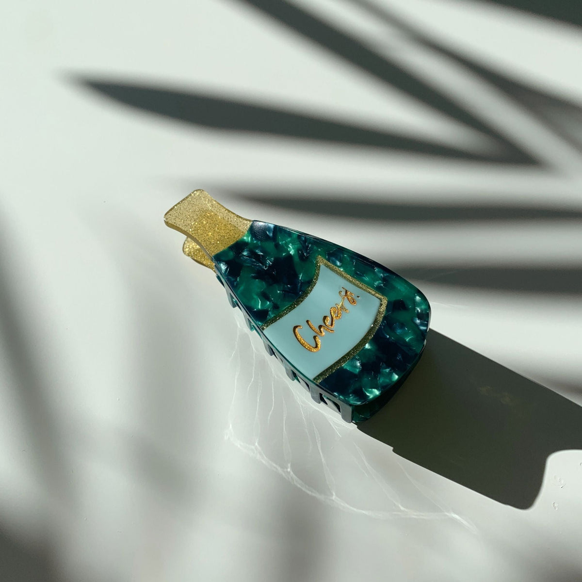 Teal and blue marbled hair claw with gold glitter accent and clear side opening