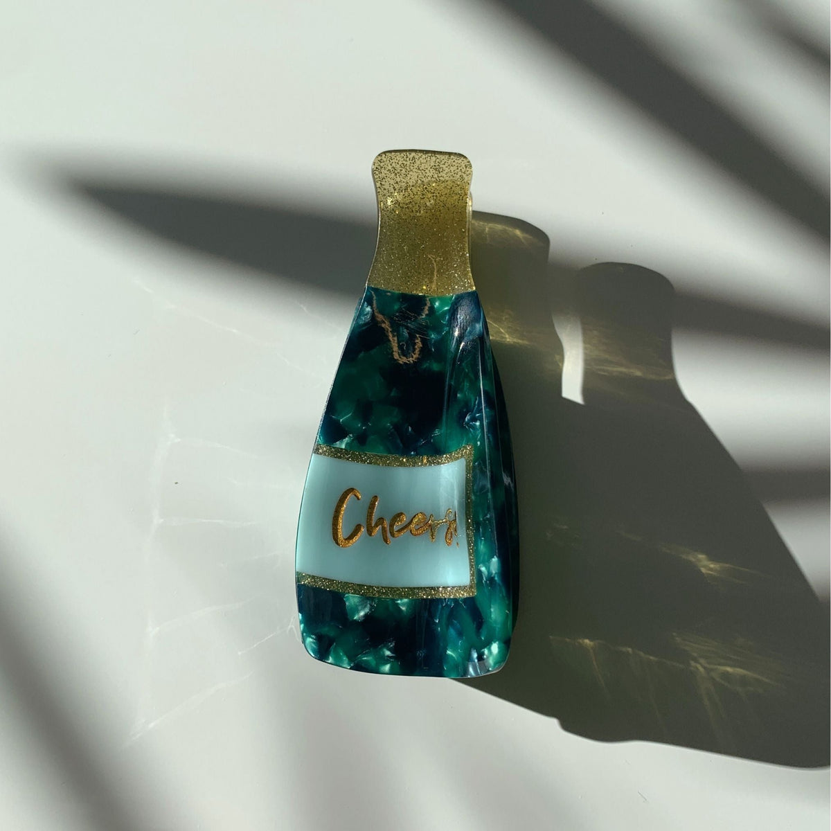 Teal marbled hair claw with gold glitter top and cream center panel
