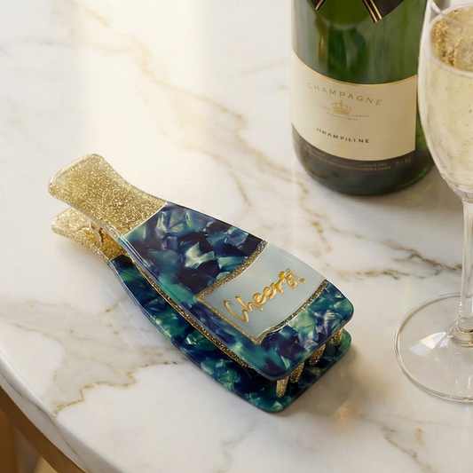 Teal and blue marbled hair claw with gold glitter top and engraved center panel
