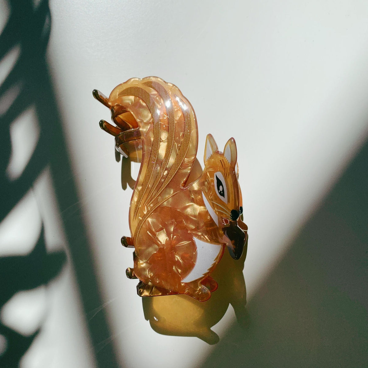 Amber squirrel hair claw close-up with curved clasp and dark nose
