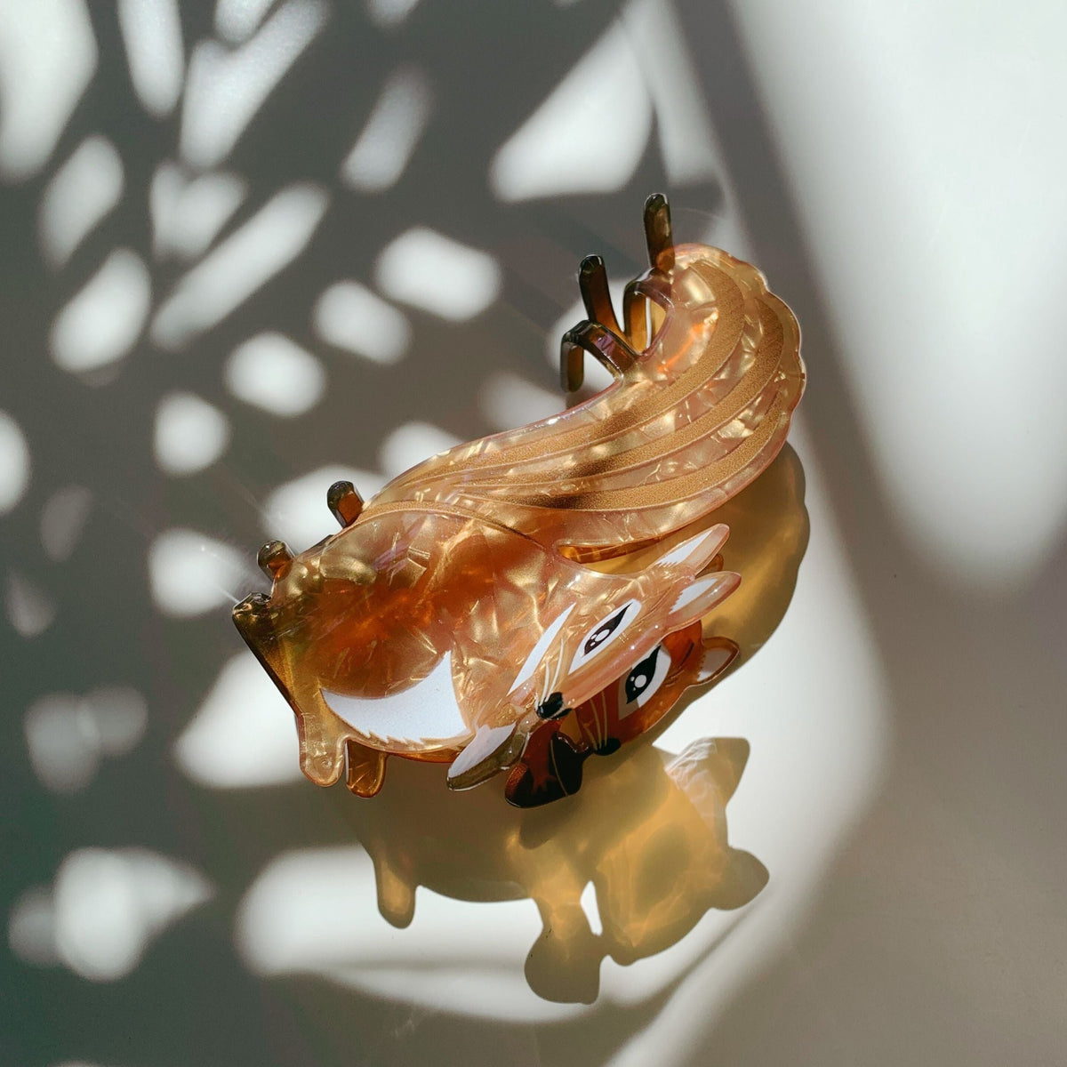 Amber squirrel hair claw underside view with metal prongs visible
