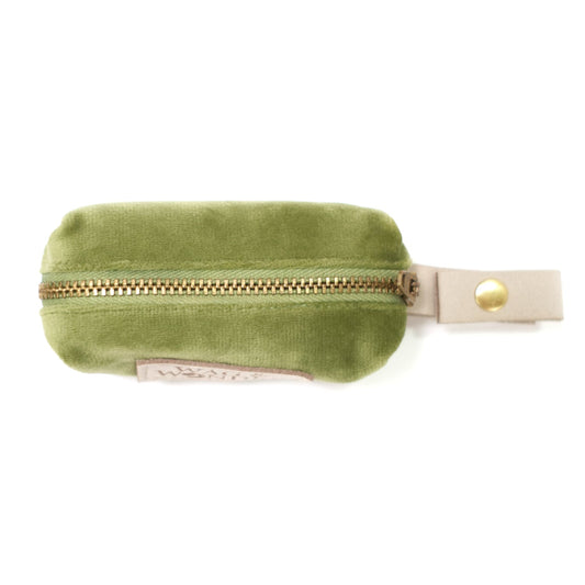 Green velvet waste bag holder with zipper and white clip for attachment