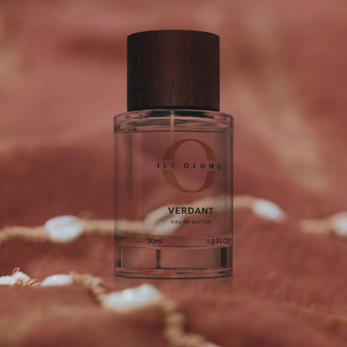 Eau de parfum bottle with dark wood cap in clear glass, 30 ml