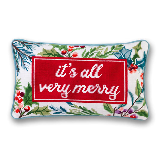 Needlepoint holiday throw pillow with red “It’s all very merry” banner on white