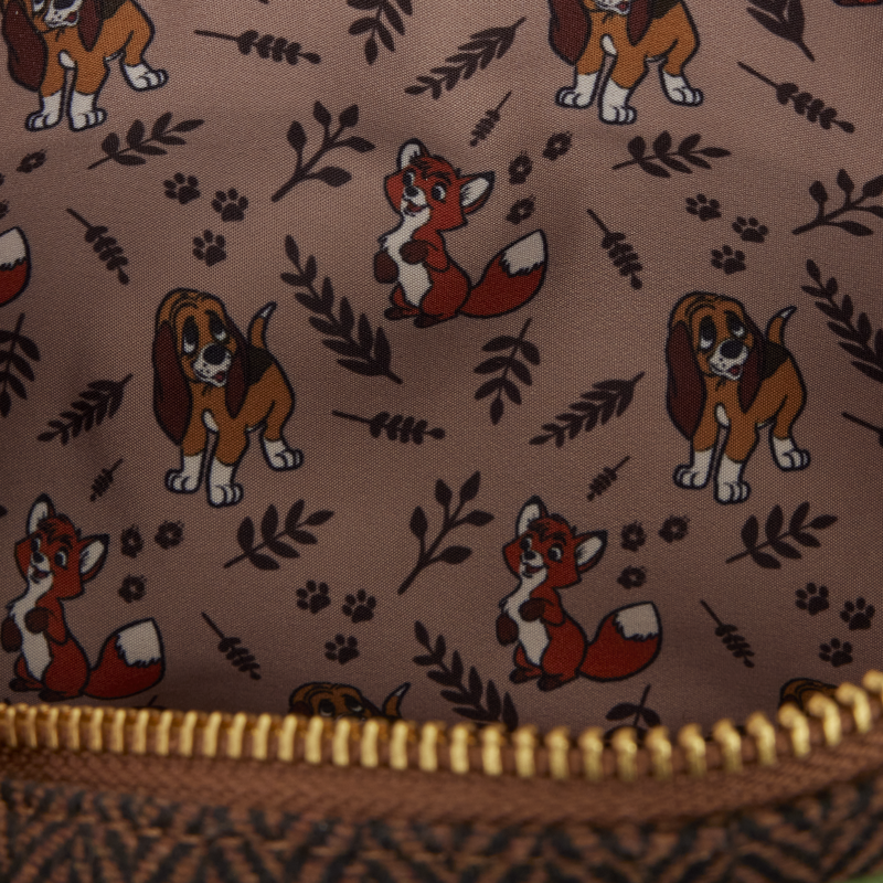 Bag lining printed with fox and hound characters, paw prints, and leafy motifs