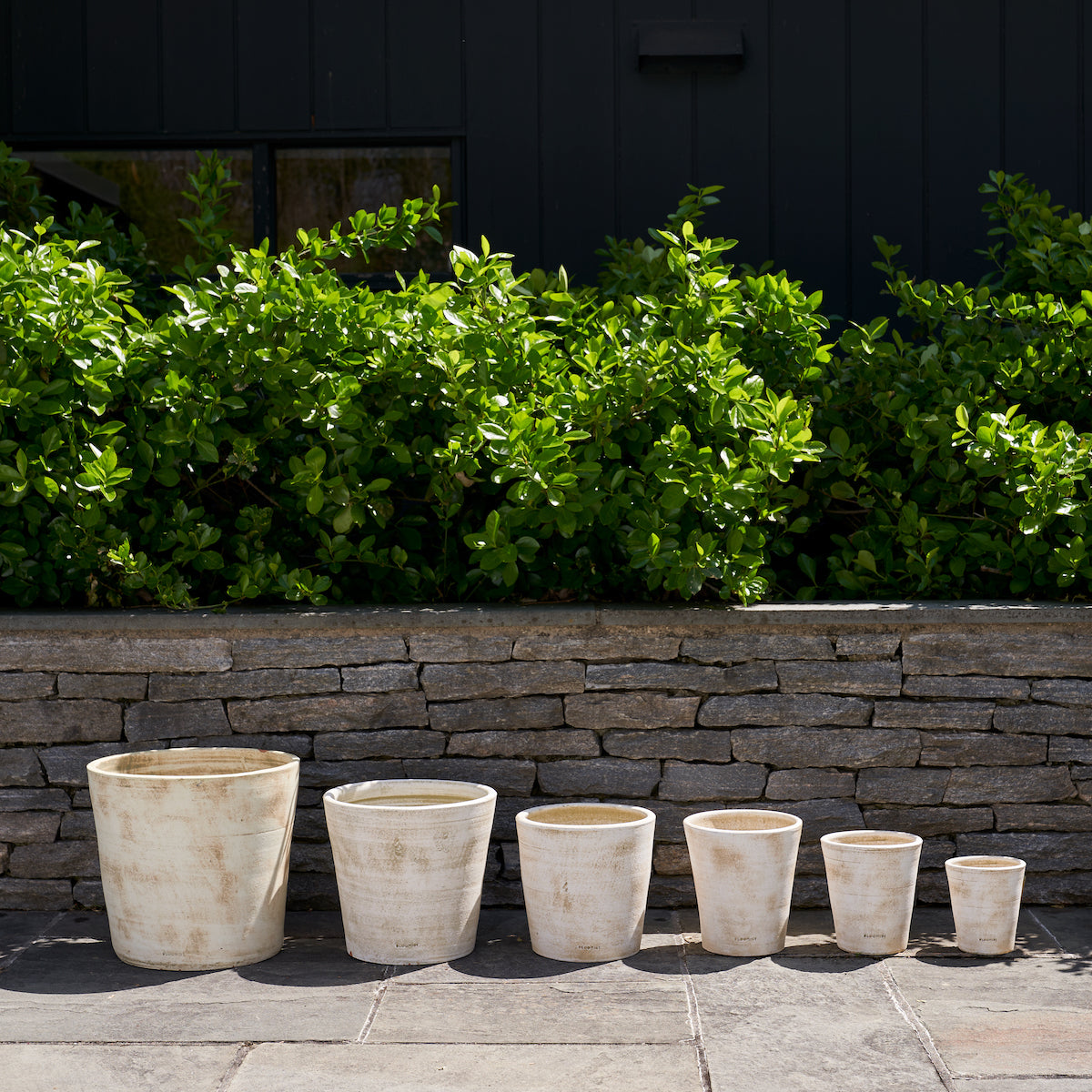 Group of white patina terra-cotta planters, varying heights for plants