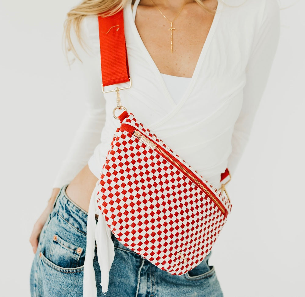 Red-and-white checkered woven bum bag with gold zipper and adjustable strap