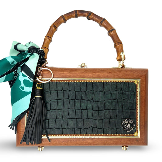 Wooden box handbag with green crocodile-look front, bow ribbon, and black tassel