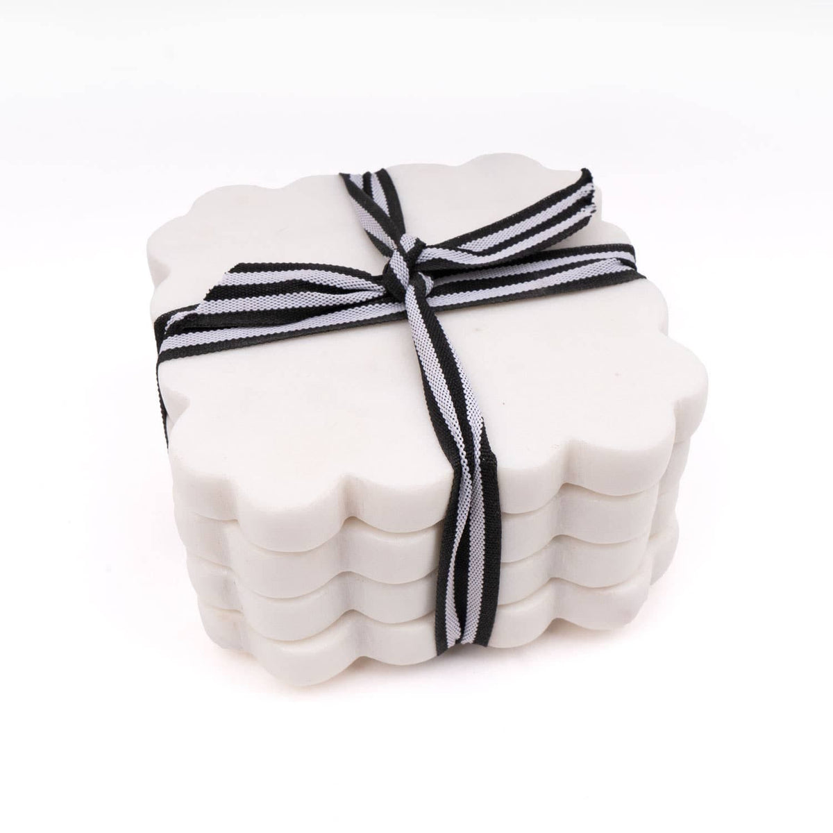 Stack of scalloped white coasters tied with black-and-white striped ribbon