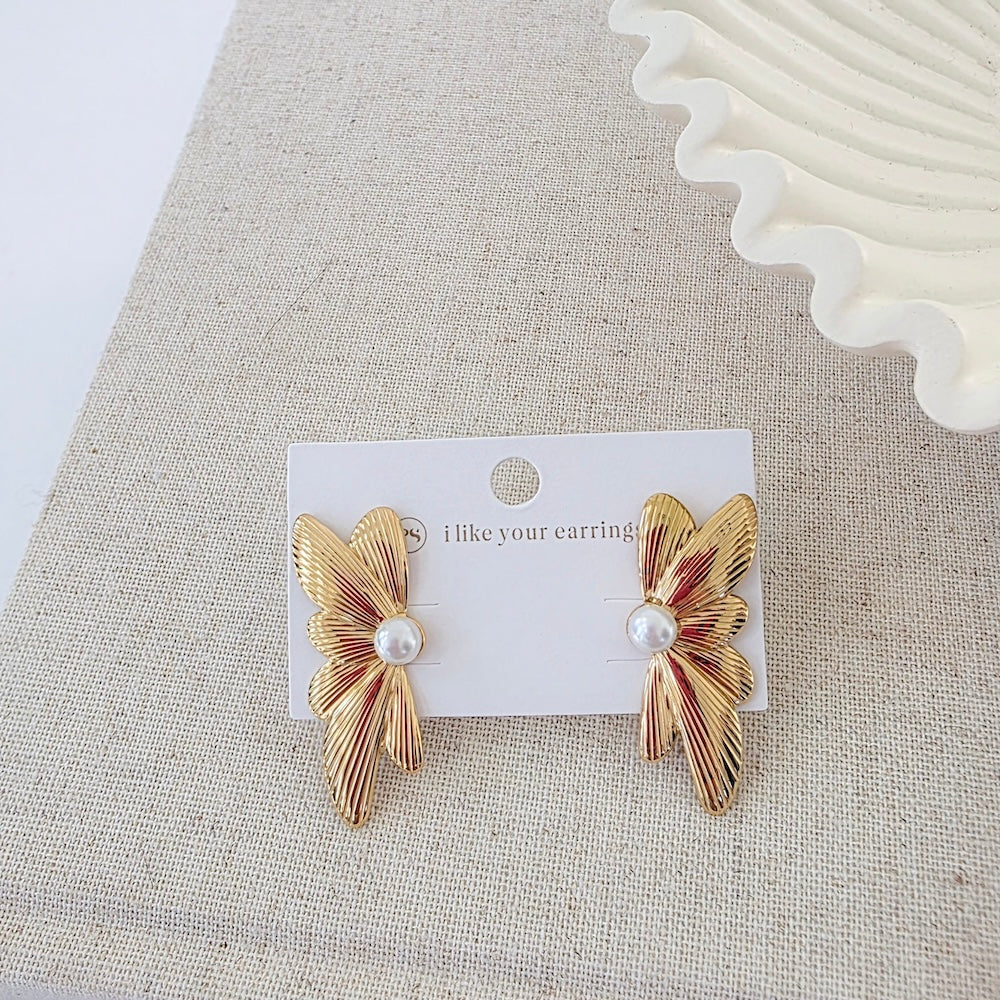 Pair of gold winged floral earrings with white pearl beads on card