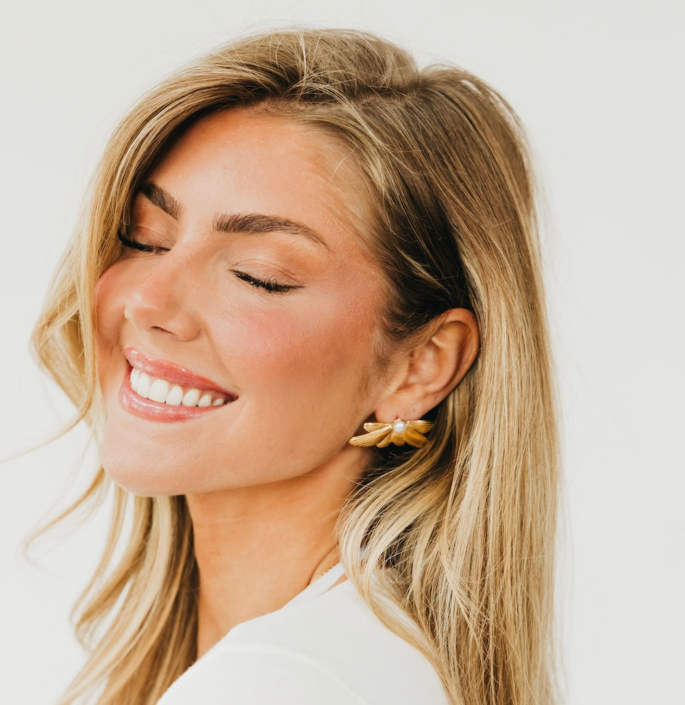 Gold winged floral earrings with white pearl inset