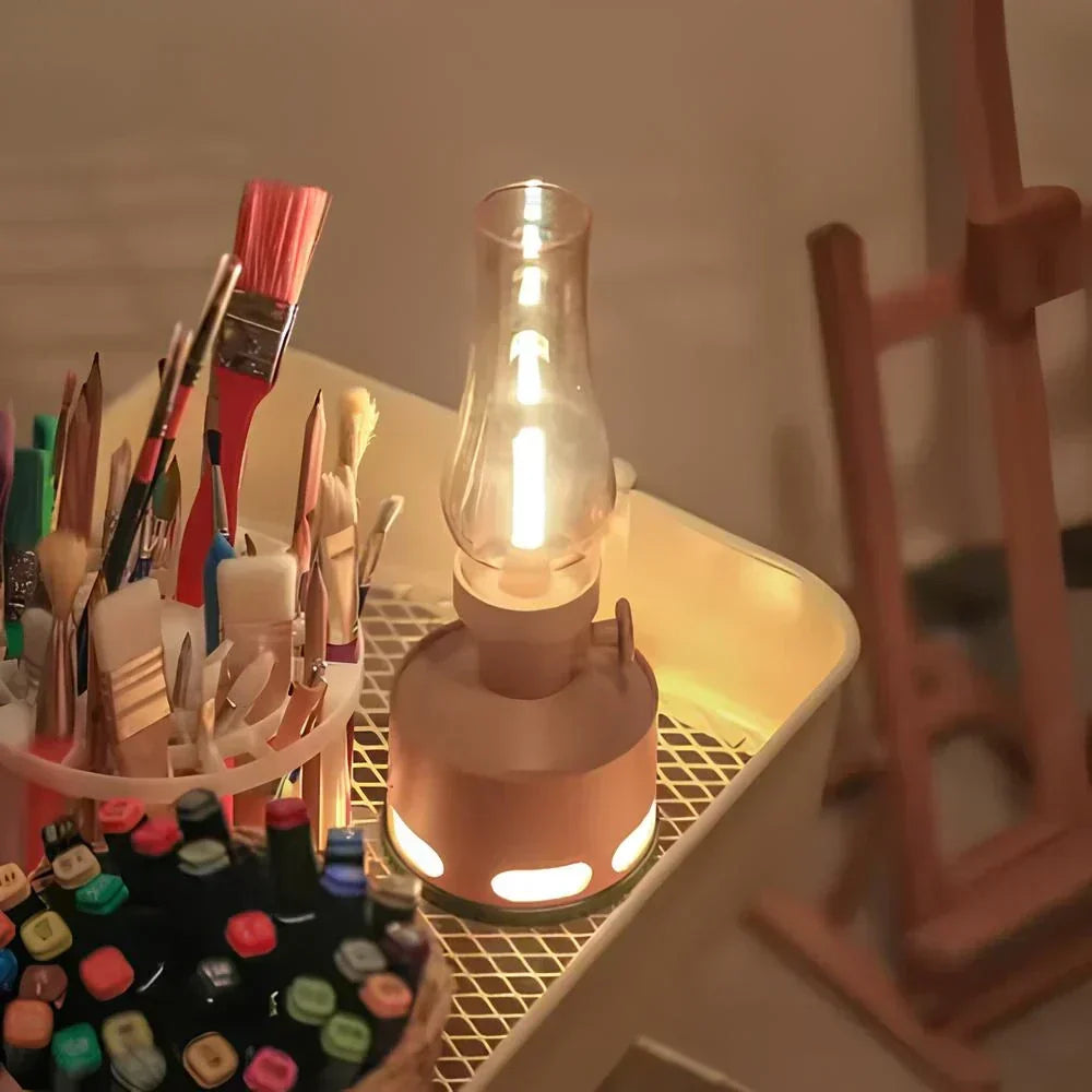 Portable LED lantern with a clear chimney and glowing base lights