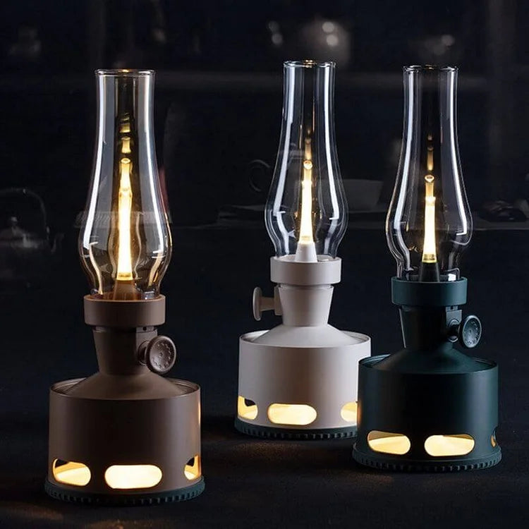 Three vintage LED lanterns in brown, gray, and green with glass chimneys