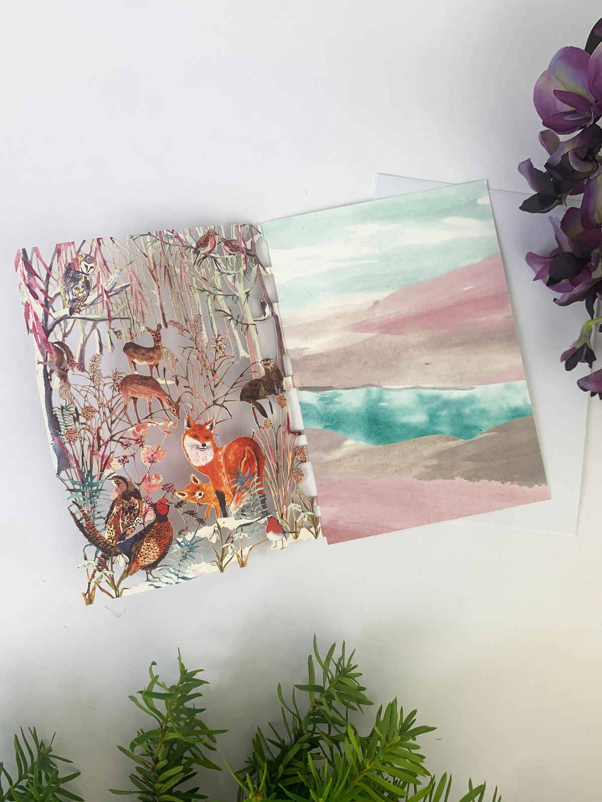 Laser-cut Christmas card with fox and woodland animals scene, open front view