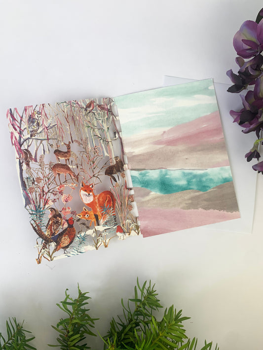 Laser-cut Christmas card with fox and woodland animals scene, open front view