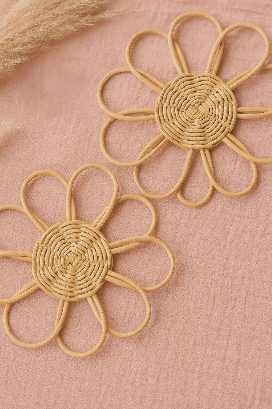 Close-up of two woven natural rattan flower wall decorations