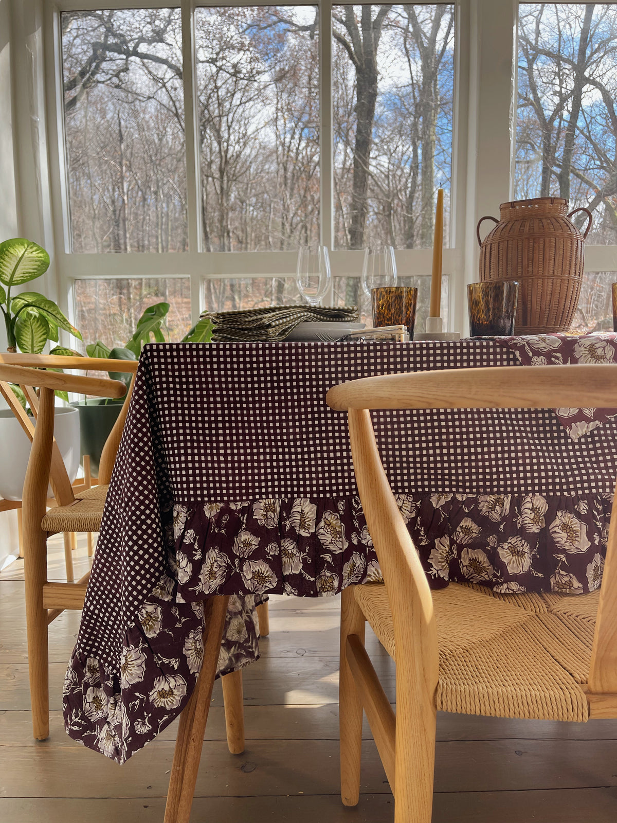 Wine gingham tablecloth with a full floral ruffle hanging around the table