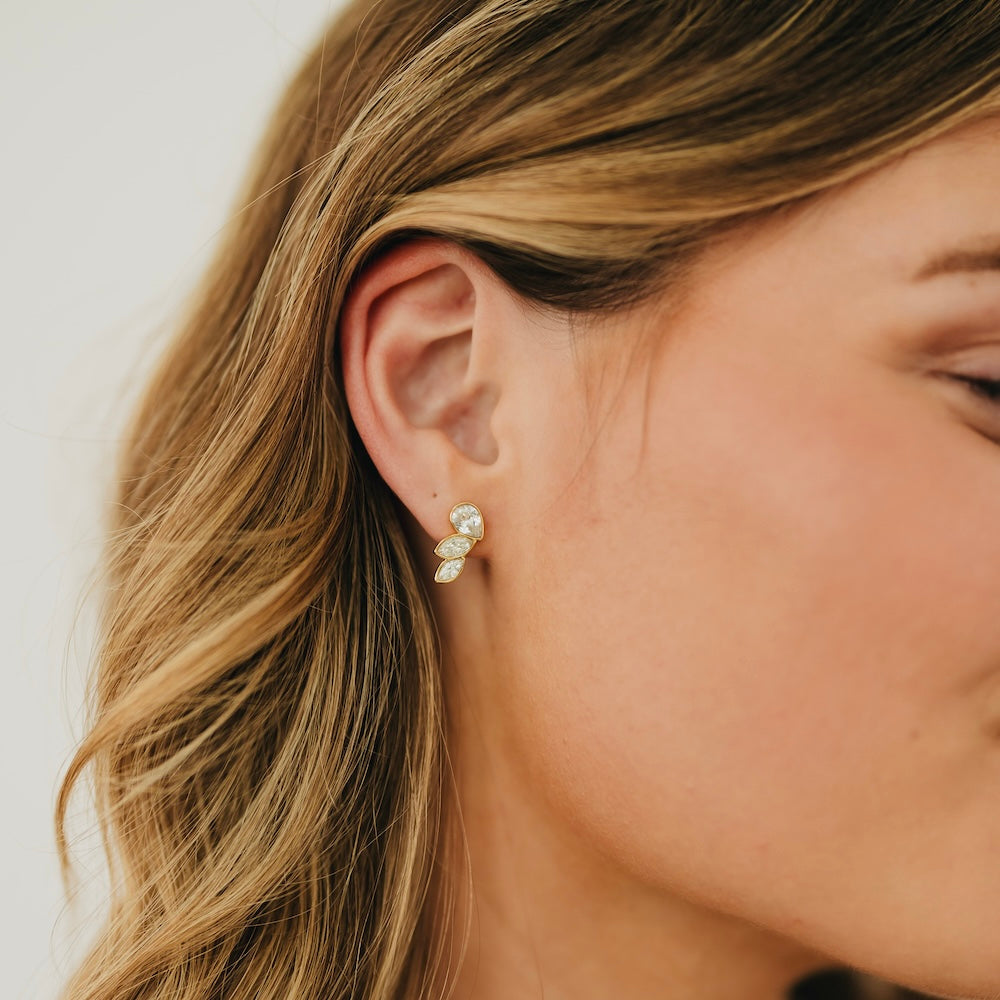 Gold-tone angel wing stud earrings, side view, crystal-like stones