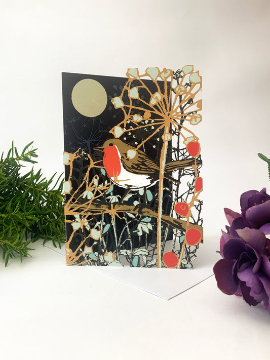 Christmas card with robin and moon, laser-cut forest and red berry illustrations