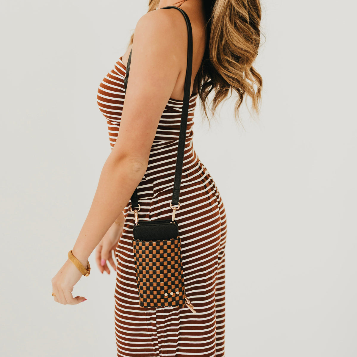 Checkered woven phone bag in brown and black with crossbody strap