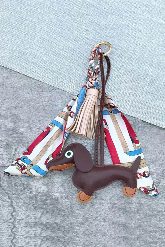 Dachshund leather bag charm with brown dog, beige scarf ring with blue and red stripes