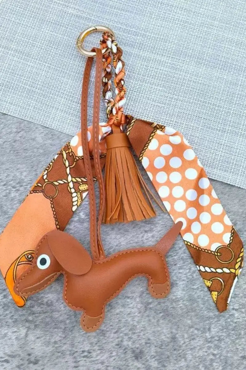 Dachshund leather bag charm with brown tassel, orange scarf ring with polka-dot print