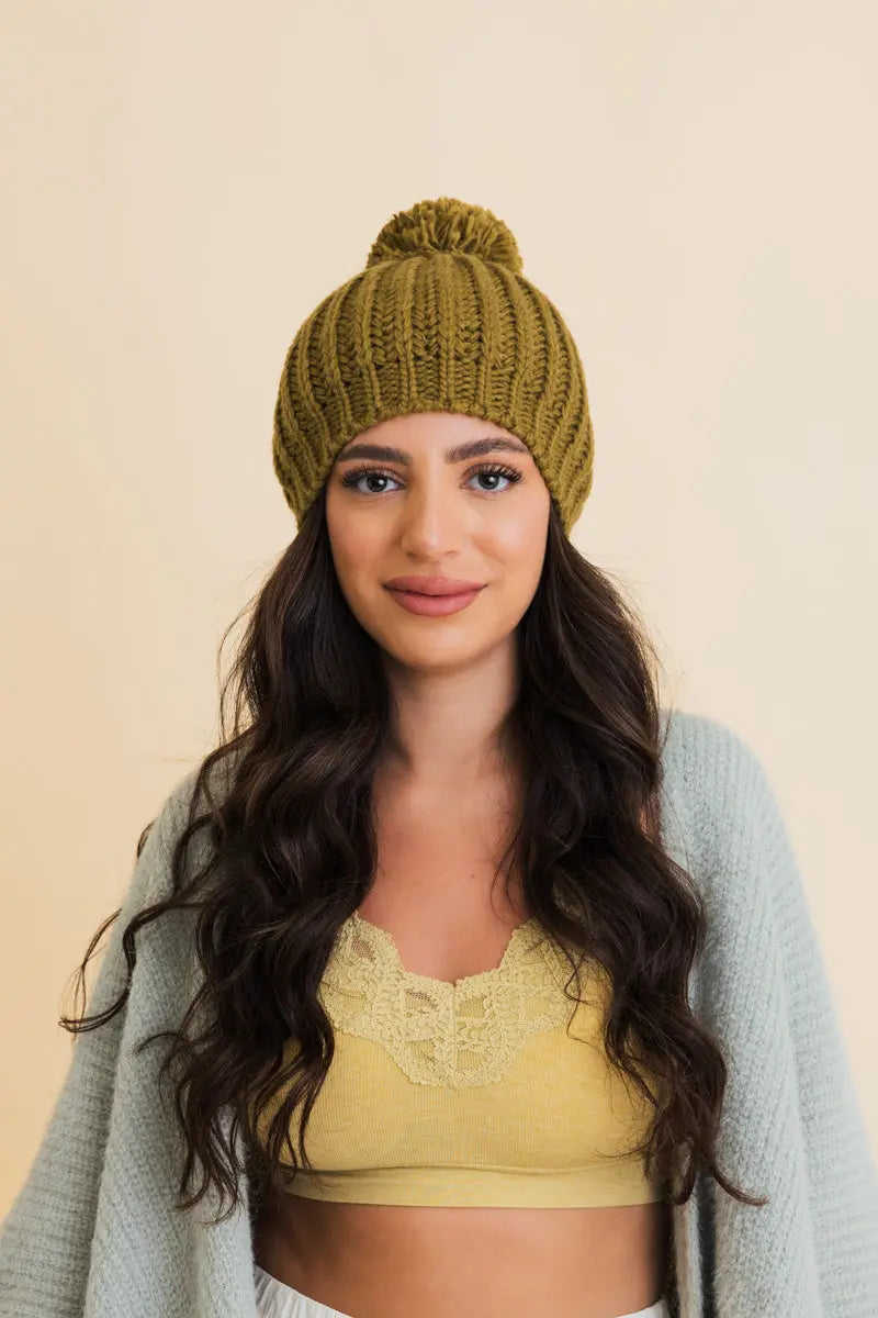 Army green chunky cable knit beanie with top pom and ribbed brim