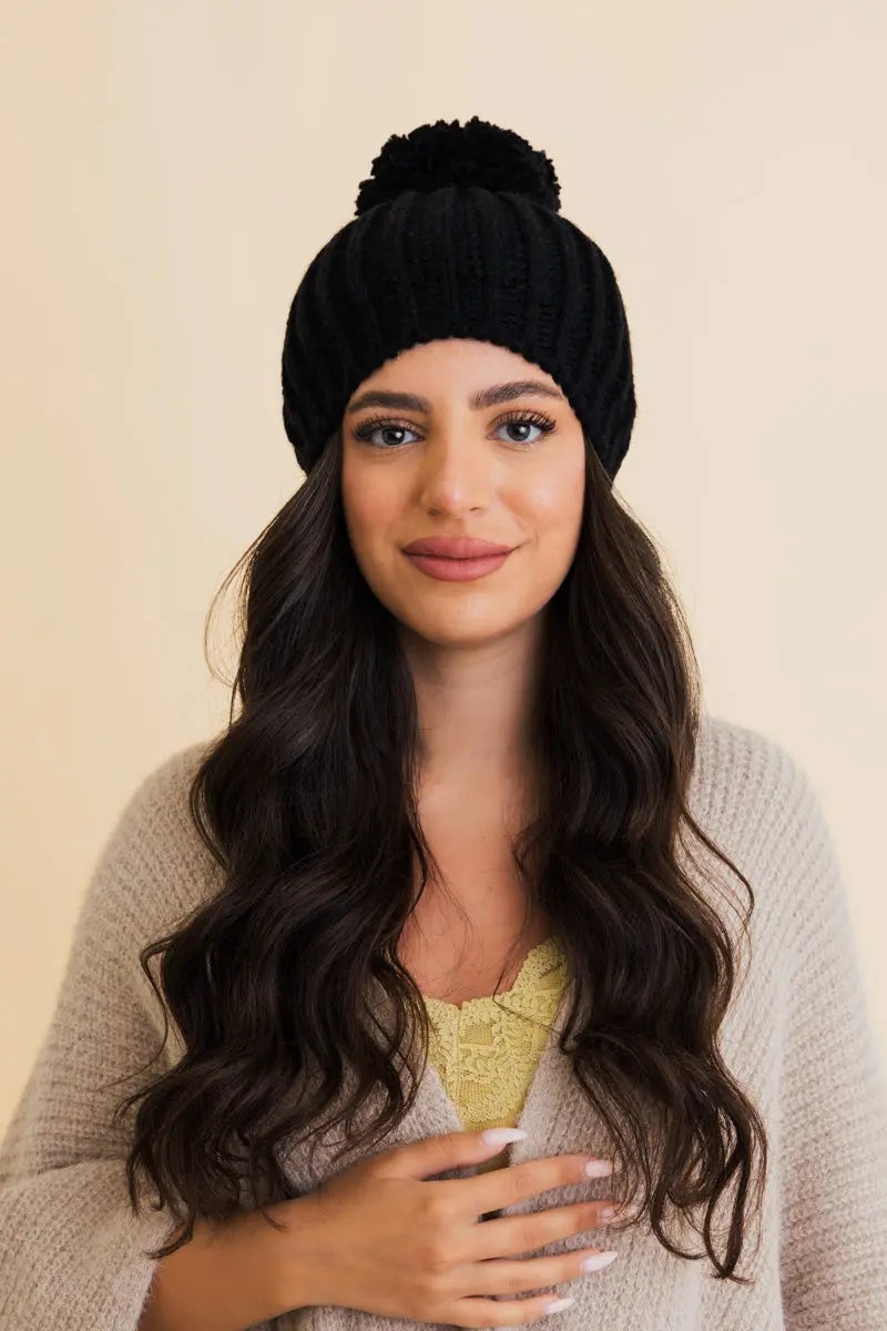 Black chunky cable knit pom beanie with ribbed brim and pom top